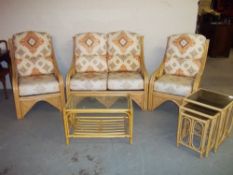 A FIVE PIECE BAMBOO CONSERVATORY SUITE COMPRISING A TWO SEATER SOFA, TWO CHAIRS, A COFFEE TABLE