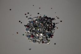 A BAG OF LOOSE MIXED STONES INCLUDING CUBIC ZIRCONIA, RUBY, EMERALD, SAPPHIRE, AMETHYST AND
