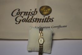 A 9 CT GOLD LADIES ACCURIST WRIST WATCH