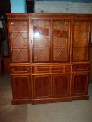A BREAKFRONT WALL DISPLAY UNIT WITH LEATHER INLAID PULL OUT WRITING DESK