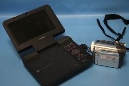 A TOSHIBA PORTABLE DVD PLAYER TOGETHER WITH A PANASONIC CAMERA