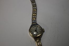 A LADIES 9 CT GOLD UNO WRIST WATCH ON PLATED STRAP