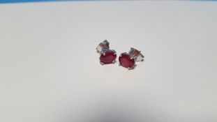 A PAIR OF TREATED RUBY SILVER STUDS