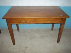 A SOLID OAK DESK WITH TWO DRAWERS