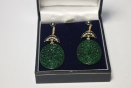 A PAIR OF OVAL SHAPED PATTERNED JADE DROP EARRINGS SET WITH DIAMONDS AND INLAID WITH BLACK ENAMEL,