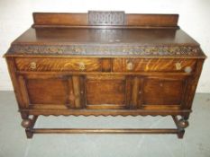 AN ANTIQUE OAK SIDEBOARD