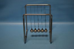 A SET OF NEWTON'S SWINGING BALLS