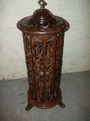 A DECORATIVE CAST CYLINDRICAL STAND ALONE LOG BURNER