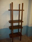 A HEAVY MAHOGANY SHELF UNIT