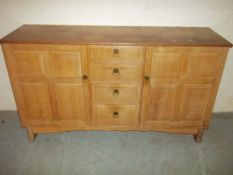 A RETRO OAK SIDEBOARD WITH PANELLED DOORS MADE BY REYNOLDS OF LUDLOW