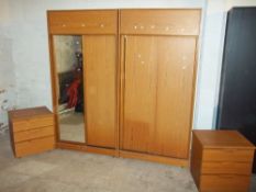 A MODERN FOUR PIECE BEDROOM SUITE CONSISTING OF TWO WARDROBES AND TWO CHESTS OF DRAWERS
