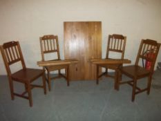 A PINE DINING TABLE WITH FOUR CHAIRS