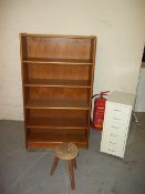 A RETRO TEAK BOOKSHELF, A MILKING STOOL AND A TOOL CABINET