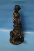 A BRONZED STYLE FIGURING OF A LADY WITH DOG