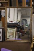A GILT FRAMED MIRROR 129 X 99 CM