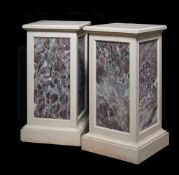 A pair of stone and fleur de pêcher marble inset plinths