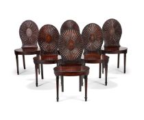 A set of six late George III mahogany hall chairs, circa 1790