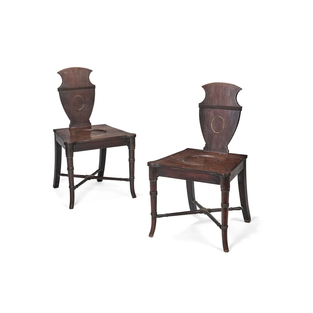 A pair of late George III mahogany hall chairs, circa 1800