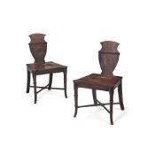 A pair of late George III mahogany hall chairs, circa 1800