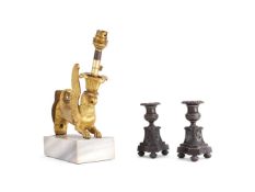 A pair of Empire patinated bronze candle holders, circa 1810, and a Regency gilt bronze mount refitt