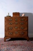 A George I walnut and feather banded chest of drawers, circa 1720