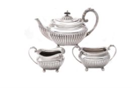 A silver three piece oblong tea set by James Dixon & Son