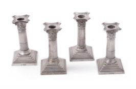 Four late Victorian silver Corinthian candlesticks by William Hutton & Sons Ltd.