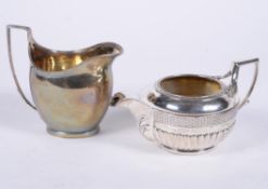 A George III silver circular cream jug by Joseph Guest