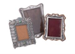 Three silver or silver coloured photograph frames