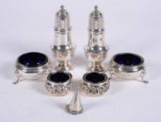 A pair of silver baluster pepperettes and cauldron salts by Crichton Brothers