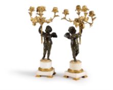A pair of French gilt bronze and white marble mounted figural four light candelabra