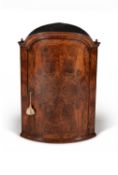 A Queen Anne figured and burr walnut bowfront corner cupboard, circa 1710