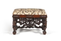 A carved walnut stool, in late 17th century style, in the manner of designs by Daniel Marot