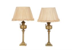 A pair of late Victorian gilt brass table oil lamps