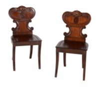 A pair of George IV mahogany hall chairs