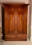A Regency mahogany and brass strung wardrobe