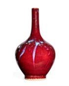 A pair of Chinese sang-de-boeuf glazed bottle vases