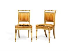 A pair of late George III white painted and parcel giltwood side chairs