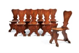 A set of eight George II mahogany hall chairs