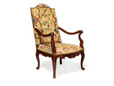 A French walnut and tapestry upholstered open armchair in Louis XV style