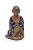 A Chinese gilt bronze and champlev enamel figure of luohan