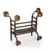 A Charles II wrought iron and brass fire grate
