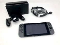 A pre-owned Nintendo Switch Console (Factory reset, some light scratches to screen glass) with