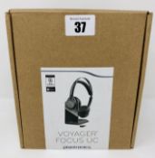 A boxed as new Plantronics Voyager Focus UC B825-M Stereo Bluetooth Headset (Box opened).