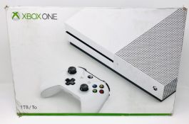 A boxed as new Microsoft Xbox One 1TB Console in White (Box sealed, some cosmetic damage to box).