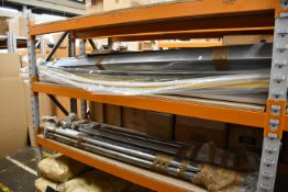 A shelf of miscellaneous items to include plastic tubing and metal support brackets.