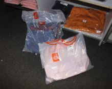 One Big Go-Bag in midnight blue, one Day Duffle in cloud pink and one Pouch in parfait pink, all