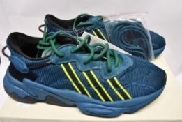 A pair of as new Adidas X Pusha T Ozweego trainers (UK 6).