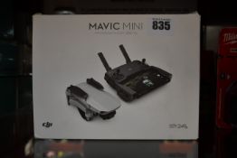 A pre-owned boxed DJI Mavic Mini Drone with controller in light grey (Some scratches on blades,