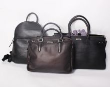 Two as new black leather Bolongaro Trevor bags and one other black leather back pack bag with